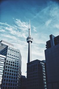 CN Tower and office buildings against blue skies - Inderly IT (Toronto)