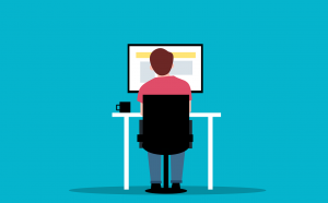 Cartoon image of person sitting at computer desk